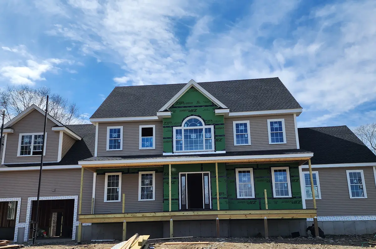 Beige house under construction with house framing services